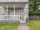 Charming front porch featuring a brick walkway, railing, and classic architectural details at 914 English Ave, Indianapolis, IN 46203