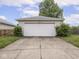 Two car garage with a concrete driveway and manicured bushes at 914 English Ave, Indianapolis, IN 46203