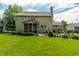 Backyard featuring a lush lawn, mature trees, and a patio with outdoor seating at 9804 Wentworth Ct, Carmel, IN 46032