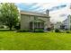 Backyard featuring a lush lawn, mature trees, and a patio with outdoor seating and dining at 9804 Wentworth Ct, Carmel, IN 46032