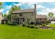 Backyard featuring a lush lawn, mature trees, and a patio with outdoor seating at 9804 Wentworth Ct, Carmel, IN 46032