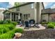 Backyard with a patio dining area, comfortable seating around a fire pit, and lush green landscaping at 9804 Wentworth Ct, Carmel, IN 46032