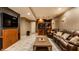 Entertain in this finished basement featuring a bar area, seating, and a large TV at 9804 Wentworth Ct, Carmel, IN 46032
