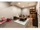 Basement playroom featuring an area rug, a play table and toys, and a storage unit at 9804 Wentworth Ct, Carmel, IN 46032