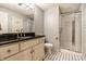 Bathroom featuring a stand-up shower with glass door, tile flooring, and a light-colored vanity at 9804 Wentworth Ct, Carmel, IN 46032