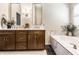 Elegant bathroom featuring double sinks, a soaking tub with marble surround, and modern fixtures at 9804 Wentworth Ct, Carmel, IN 46032