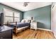 Cozy bedroom with a wood-frame bed, white nightstand, and large windows for natural light at 9804 Wentworth Ct, Carmel, IN 46032