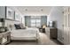 Bright bedroom with a king-sized bed, window shutters, and comfortable seating area at 9804 Wentworth Ct, Carmel, IN 46032