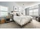 Serene bedroom with a king-sized bed, arched window, and ample natural light at 9804 Wentworth Ct, Carmel, IN 46032
