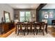 Formal dining area with seating for eight, hardwood floors, modern decor, and a view of the living area at 9804 Wentworth Ct, Carmel, IN 46032