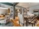 Elegant dining room featuring hardwood floors, neutral paint, a modern table set for eight, and natural light at 9804 Wentworth Ct, Carmel, IN 46032