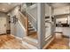 Inviting entryway with hardwood floors, stairs and a view into the kitchen at 9804 Wentworth Ct, Carmel, IN 46032