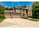 Charming brick two-story home featuring a spacious driveway, attached two-car garage, and meticulously manicured lawn at 9804 Wentworth Ct, Carmel, IN 46032