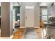Bright foyer featuring hardwood floors, neutral paint, an elegant entry door, and access to the living area at 9804 Wentworth Ct, Carmel, IN 46032
