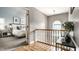 Hallway leading to a bedroom with hardwood floors and natural light from an arched window at 9804 Wentworth Ct, Carmel, IN 46032