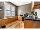 Dedicated home office featuring built-in cabinets, a spacious desk, hardwood floors, and lots of natural light at 9804 Wentworth Ct, Carmel, IN 46032
