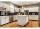 Bright kitchen featuring white cabinetry, stainless steel appliances, and a central island at 9804 Wentworth Ct, Carmel, IN 46032