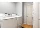 Clean laundry room features a modern washer and dryer, with a doorway to additional storage at 9804 Wentworth Ct, Carmel, IN 46032