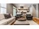 Cozy living room with hardwood floors and open view to the kitchen, perfect for Gathering gatherings at 9804 Wentworth Ct, Carmel, IN 46032