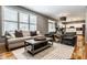 Bright living room with seating, rug, and a view into the modern kitchen at 9804 Wentworth Ct, Carmel, IN 46032