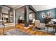 Open-concept living space featuring hardwood floors, neutral walls, natural light, and access to the dining area at 9804 Wentworth Ct, Carmel, IN 46032