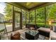 Cozy sunroom showcasing comfortable seating, tiled floor, and view of the backyard at 9804 Wentworth Ct, Carmel, IN 46032
