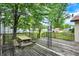 Wooden back deck featuring wooden picnic table, black metal pergola, and view of large grassy backyard at 101 Heiny Rd, Indianapolis, IN 46217