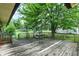 Wide-angle view of the wooden back deck with picnic table, overlooking the yard and neighborhood at 101 Heiny Rd, Indianapolis, IN 46217