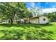 Image of the backyard featuring a lush green lawn, mature trees, and a welcoming outdoor space at 101 Heiny Rd, Indianapolis, IN 46217