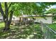 View of the backyard with a wooden deck, small patio, and a well-maintained lawn, offering a great outdoor space at 101 Heiny Rd, Indianapolis, IN 46217