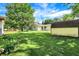 View of the backyard with lush green grass and storage shed, with house and deck in background at 101 Heiny Rd, Indianapolis, IN 46217