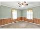 A bedroom features wainscotting, wood paneling, and a ceiling fan at 101 Heiny Rd, Indianapolis, IN 46217