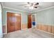 A bright bedroom featuring a ceiling fan, closet, and an open doorway to another room at 101 Heiny Rd, Indianapolis, IN 46217