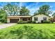 Charming ranch home with a well-manicured lawn, attached garage, and inviting front porch at 101 Heiny Rd, Indianapolis, IN 46217