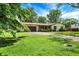 Charming one-story home with a manicured lawn, mature trees, attached garage, and welcoming curb appeal at 101 Heiny Rd, Indianapolis, IN 46217