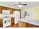 An eat-in kitchen features wooden cabinets, white appliances, and an island at 101 Heiny Rd, Indianapolis, IN 46217