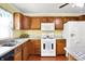 The kitchen features wooden cabinets, black appliances, white appliances, and a sink at 101 Heiny Rd, Indianapolis, IN 46217