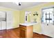A kitchen features light yellow walls, an island, and a view into the dining area at 101 Heiny Rd, Indianapolis, IN 46217