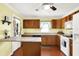 A yellow kitchen features wooden cabinets and white appliances at 101 Heiny Rd, Indianapolis, IN 46217