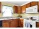 A kitchen features wooden cabinets, a white microwave, and an oven at 101 Heiny Rd, Indianapolis, IN 46217