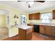 A kitchen features wooden cabinets, black appliances, a peninsula, and a view into another room at 101 Heiny Rd, Indianapolis, IN 46217