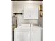 Laundry room with washer, dryer, cabinets, and shelves, offering organized storage at 101 Heiny Rd, Indianapolis, IN 46217