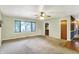 Spacious living room with a large window, ceiling fan, and doorway to the kitchen at 101 Heiny Rd, Indianapolis, IN 46217