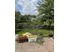 Backyard featuring a small pond surrounded by a wooden fence, and gardening equipment at 10194 Lothbury Cir, Fishers, IN 46037