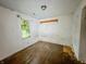 This bedroom has peeling paint, and worn wood floors at 1140 Mcdougal St, Indianapolis, IN 46203