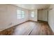 Empty bedroom with hardwood floors and two windows offering natural light, needs TLC at 1140 Mcdougal St, Indianapolis, IN 46203