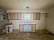 Dated kitchen featuring blue cabinets, a double sink and water heater at 1140 Mcdougal St, Indianapolis, IN 46203