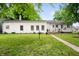 A backyard featuring a well-maintained lawn and classic white home exterior at 1212 Woodlawn Ave, Indianapolis, IN 46203
