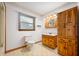 Bathroom featuring charming wooden vanity, storage cabinet and tile flooring at 1212 Woodlawn Ave, Indianapolis, IN 46203