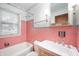 Bathroom featuring pink tile, and a bathtub, offering a retro-chic vibe at 1212 Woodlawn Ave, Indianapolis, IN 46203